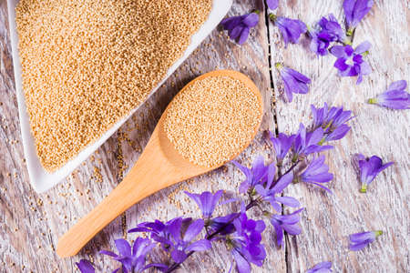 Bowl with amaranth grains on wooden background, top viewの写真素材
