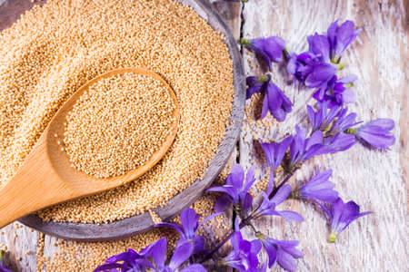Bowl with amaranth grains on wooden background, top viewの写真素材