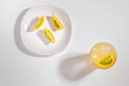 glass with juice and slices of lulo fruit, on the table, Solanum quitoenseの写真素材