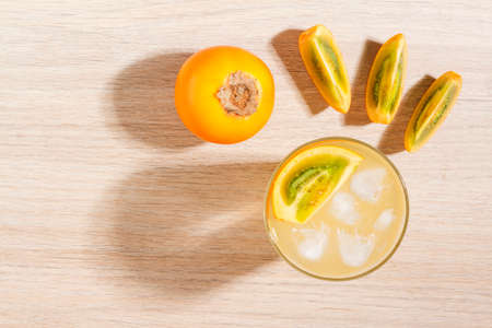 glass with juice and slices of lulo fruit, on the table, Solanum quitoenseの写真素材
