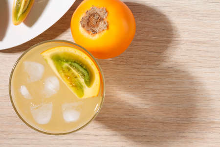 glass with juice and slices of lulo fruit, on the table, Solanum quitoenseの写真素材