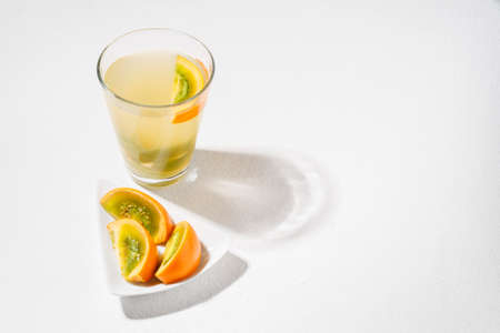 glass with juice and slices of lulo fruit, on the table, Solanum quitoenseの写真素材