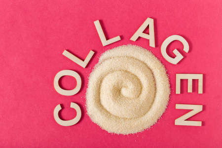 Hydrolyzed collagen on pink background, top viewの写真素材