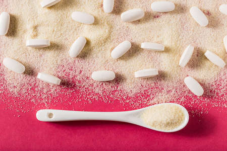 Hydrolyzed and co-compressed collagen, on pink background, top view