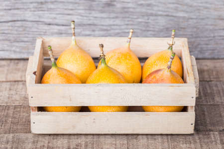 Pile of pomegranate fruits, on wooden background, close-up