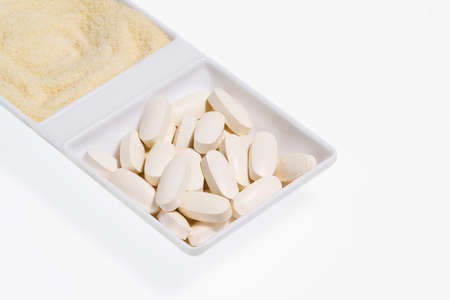 Hydrolyzed and tablet collagen isolated on white background, close-up imageの写真素材