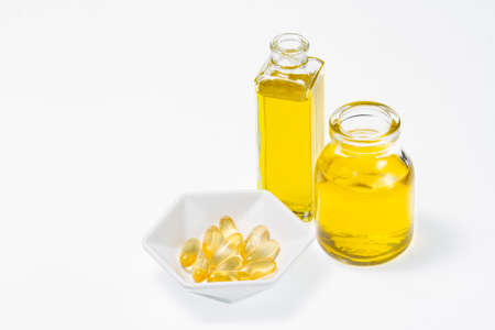 omega-3 in capsules and glass container, isolated on white backgroundの写真素材