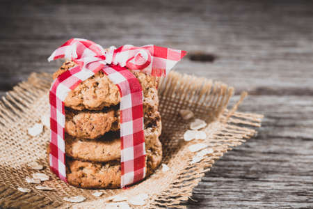 oatmeal cookies floating on wooden background, close-upの写真素材