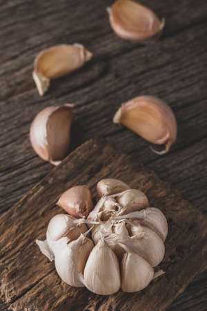 garlic and garlic powder on old wood, close up imageの写真素材