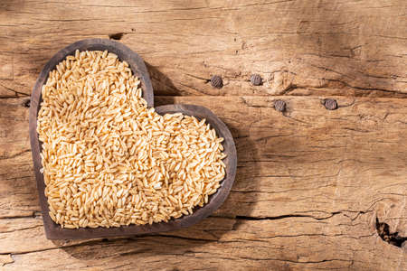 oat grains, flakes and flour on wood backgroundの写真素材