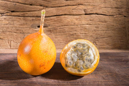 granadilla fruits on old wood, close-up imageの写真素材