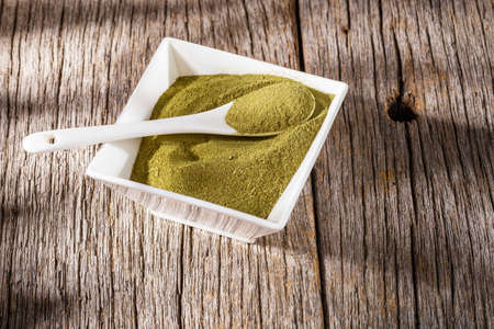 Moringa powder in bowl on the table, close up picture- Moringa Oleiferaの写真素材