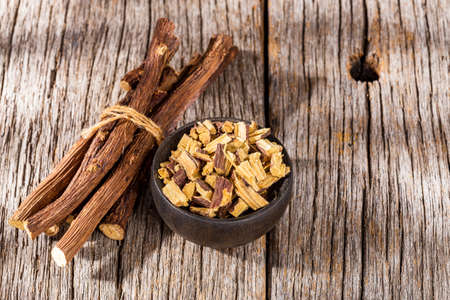 licorice root, on the wooden table - Glycyrrhiza glabraの写真素材
