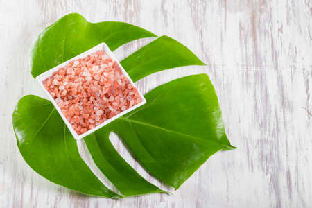 Himalayan pink salt in bowl on the table, close-up imageの写真素材
