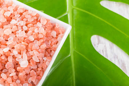 Himalayan pink salt in bowl on the table, close-up imageの写真素材
