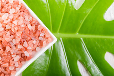 Himalayan pink salt in bowl on the table, close-up imageの写真素材