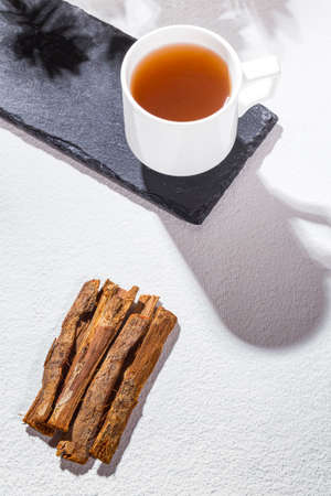 Bark and tea of cat's claw plant on white background - Uncaria tomentosaの写真素材