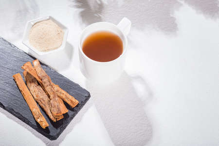 Bark and tea of cat's claw plant on white background - Uncaria tomentosaの写真素材
