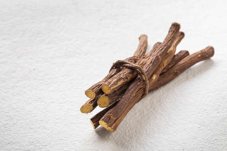 Licorice medicinal plant root, on white background - Glycyrrhiza glabra