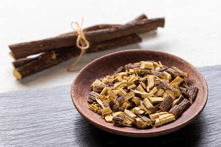Licorice medicinal plant root, on white background - Glycyrrhiza glabraの写真素材