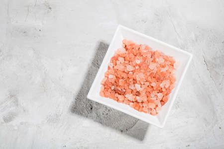 Himalayan pink salt in bowl on the table, close-up imageの写真素材