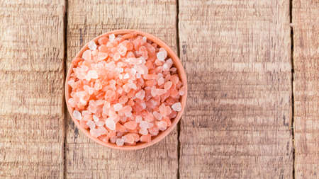 Himalayan pink salt in bowl on the table, close-up imageの写真素材