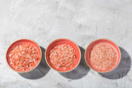 Himalayan pink salt in bowl on the table, close-up imageの写真素材