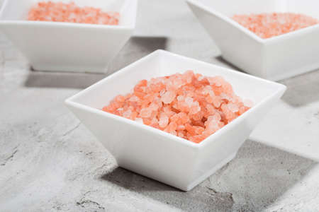 Himalayan pink salt in bowl on the table, close-up imageの写真素材