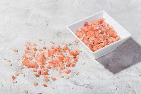 Himalayan pink salt in bowl on the table, close-up imageの写真素材