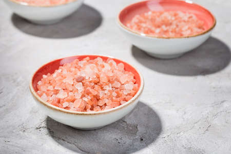 Himalayan pink salt in bowl on the table, close-up imageの写真素材