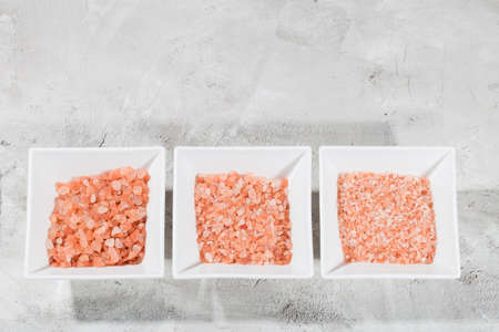 Himalayan pink salt in bowl on the table, close-up imageの写真素材
