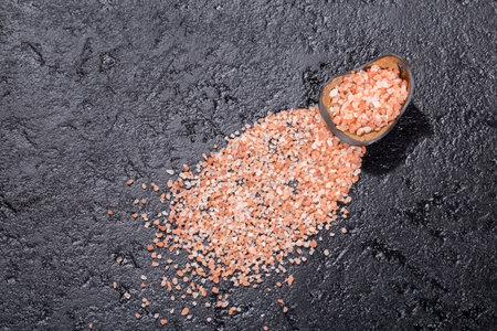 Himalayan pink salt crystals on black background, space for textの写真素材