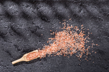 Himalayan pink salt crystals on black background, space for textの写真素材