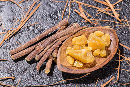 licorice root and resin on black background, close-up imageの写真素材
