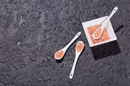 pink himalayan salt, in bowl on black backgroundの写真素材
