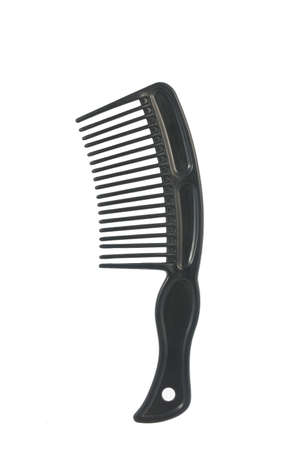 Black plastic comb on white background, close up imageの写真素材