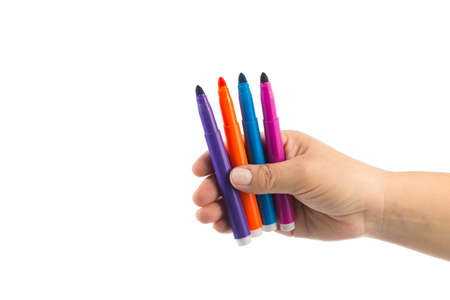 female hand holding various colored markers, isolated on white, space for textの写真素材
