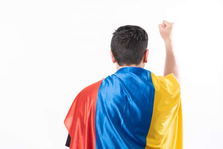 man protesting from behind with flag of Colombia, space for text