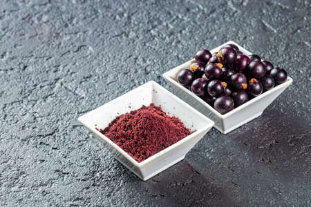 acai fruits and powder, the Amazon fruit with antioxidant powers - Euterpe oleraceaの写真素材