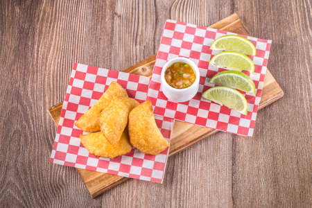 Colombian empanadas with spicy sauce on the table, top viewの写真素材