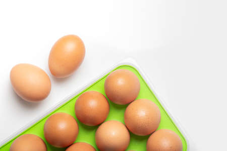 plastic basket with fresh eggs isolated on white background, space for text