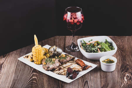 Plate of grilled meats, sangria and sauce, Colombian foodの写真素材