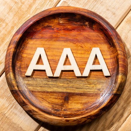 Triple A letters, in wooden bowl on the table.の写真素材