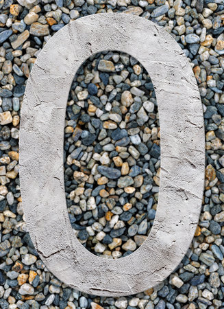 Number 0 with concrete texture, on stones backgroundの写真素材