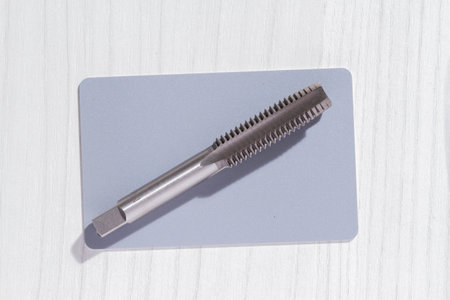 close-up image of drill bit, or tap for threads in steel, top view