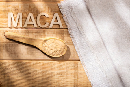 Maca powder, in wooden bowl on the table, nutritional substance from Peru.の写真素材