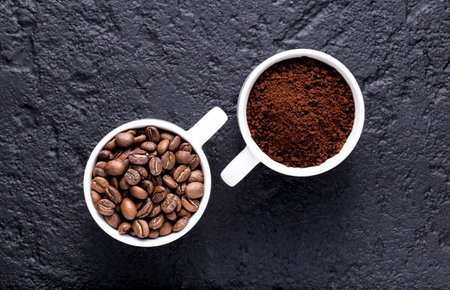 Roasted coffee beans and ground coffee, on dark background, closeup image, space for textの写真素材