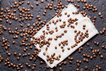 Roasted coffee beans, on dark background, closeup image, space for textの写真素材
