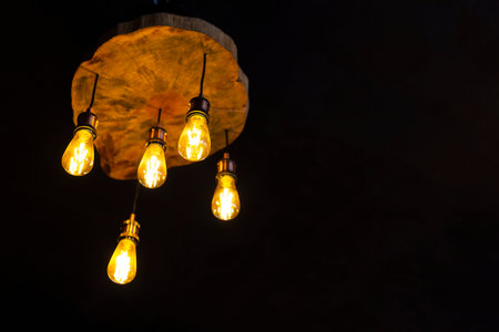 Old ceiling lamp with five bulbs on dark backgroundの写真素材