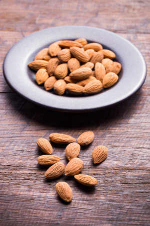 pile of natural almonds (Prunus dulcis) close-up imageの写真素材